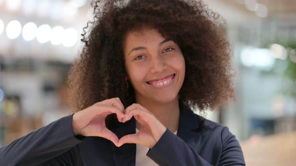 Young African Businesswoman Showing Heart Sign with Hand