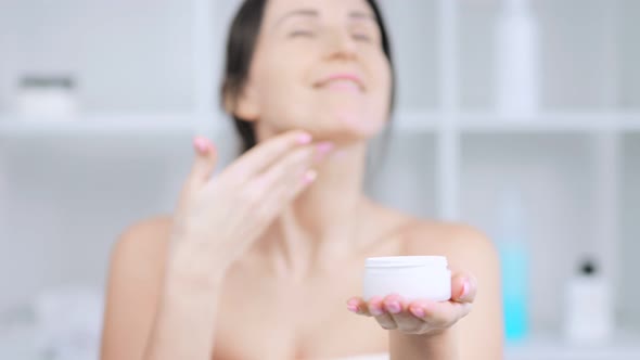 Portrait of Beautiful Fresh Young Woman Making Morning Skin Care Procedure Using Moisturizing Lotion