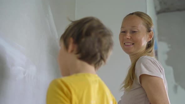 A Young Woman and Her Son are Doing a Walls Renovation in Their Home