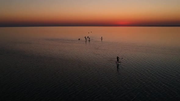 Top View of SUP Boards and Kayaks on Shallow Turquoise Water of Azov Sea at Sunset