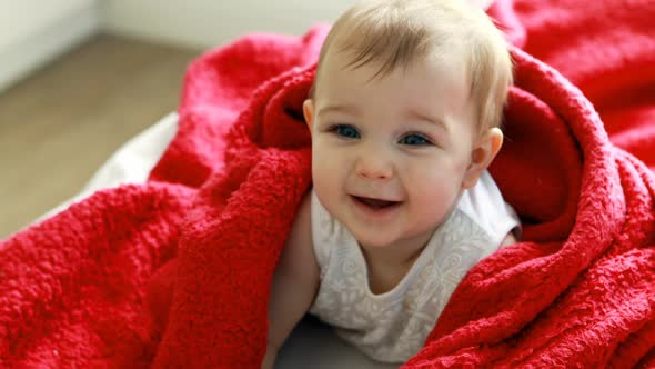 Cute baby girl on bed in bedroom