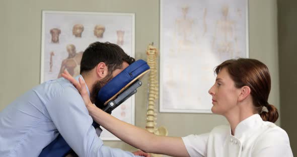 Female physiotherapist giving arm massage to a patient