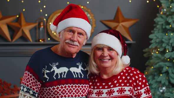 Smiling Married Senior Couple Grandparents Man Woman in Living Room Celebrating Christmas Together