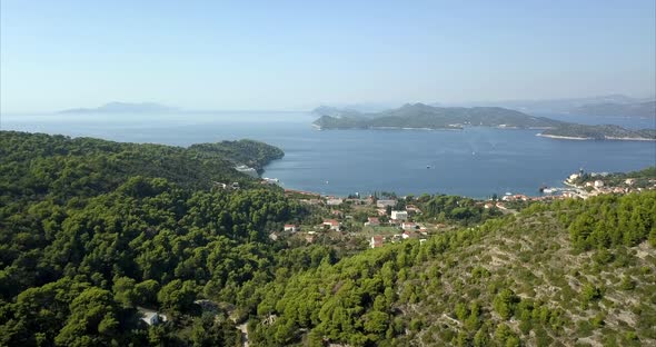 Lopud island harbour, slow reveal aerial shot. Cinematic footage on beautiful day