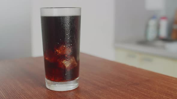 Cola drink in Transparent Glass The camera Moves Around the Table in the kitchen