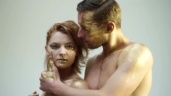 Romantic Passion Dating and Love. Beautiful Couple with Golden Art Makeup Touch Each Other. Fashion