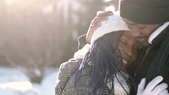 Loving African American Couple Cuddling Outside in Winter