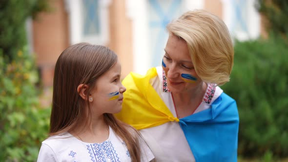 Pretty Ukrainian Daughter and Beautiful Mother Looking at Each Other Smiling Turning to Camera in