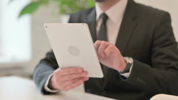 Close Up of Hands of Middle Aged Businessman Working on Tablet