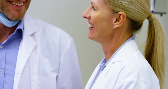 Male and female dentist interacting with each other