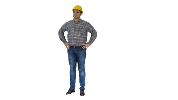 Smiling construction worker in yellow helmet looking at