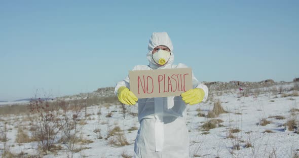 Wore in White Full Cover Suit Man Shows Sign Protest Against Plastic Pollution