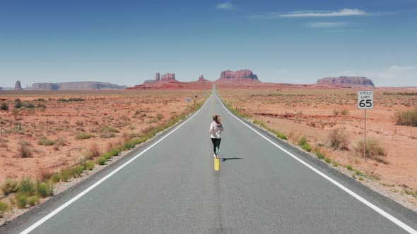 Happy Woman Running By Cinematic Landscape Feeling Freedom in Monument Valley