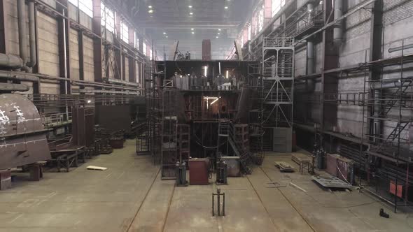 Old Restored Crab Ship with Scaffolds Stands in Dry Dock