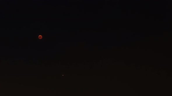 Lunar eclipse time lapse red full moon from shadow to bright and Mars Planet