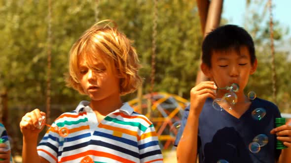 Schoolkids playing with bubble wand