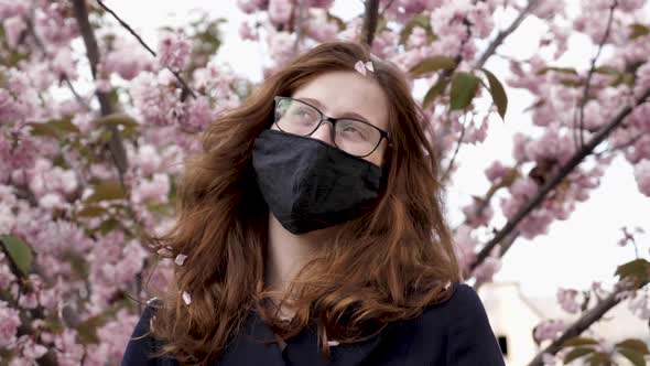 A Woman Standing in Front of a Flower Sakura