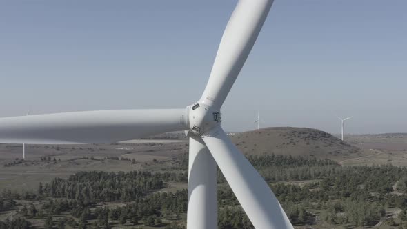 Wind turbines spin in a rural mountain landscape, Aerial view.