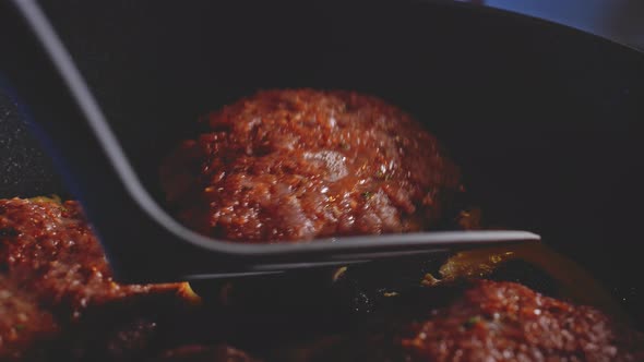 Flipping Juicy Burger Patties Cooking In A Non-stick Frying Pan. Anabolic Burger. close up