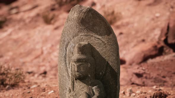 Ancient Statue on the Rocks Desert