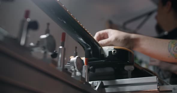 Electric Guitar is Mounted on the Jig at the Musical Instruments Repairing Shop  60p 10 Bit