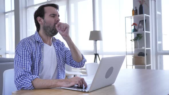 Casual Beard Man Coughing While Working on Laptop Throat Infection