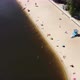 Drone Flying Along the Bank of the River Beach in the City - Resting People on the River Sandy Beach - VideoHive Item for Sale