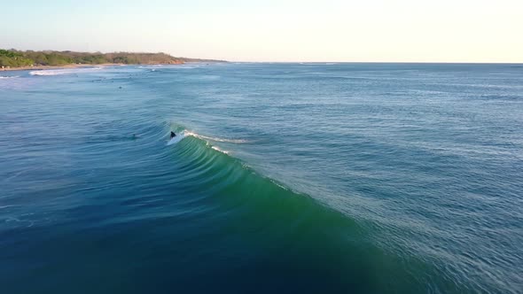 Surfer catching a wave in costa rica aerial