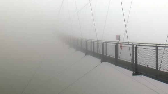 Europe's highest suspension bridge in the fog. A mysterious sight.The suspension bridge is located