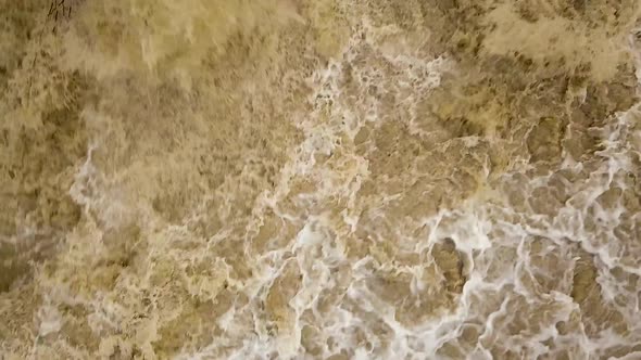 Aerial view of dirty river with muddy water in flooding period during heavy rains in spring.