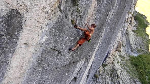 A man rock climbing up a mountain.