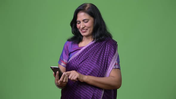 Mature Happy Beautiful Indian Woman Using Phone