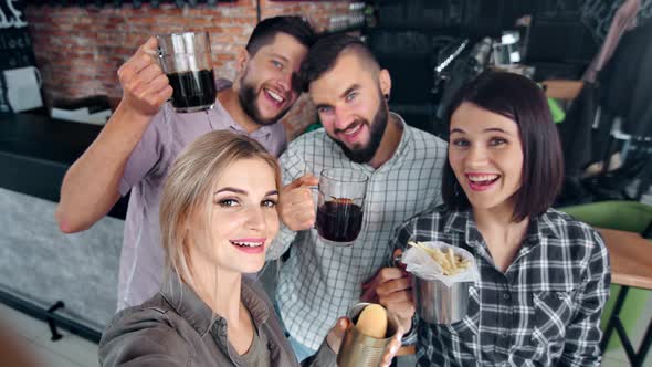 Group of Young Smiling Friend Posing with Fast Food and Beer Taking Selfie POV Shot