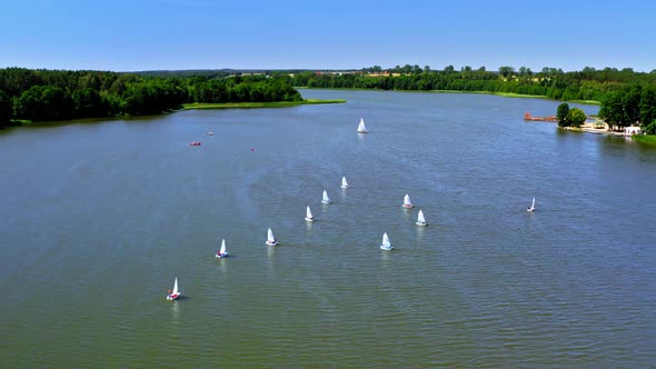 Regatta of small boats on the lake in summer, Poland from above