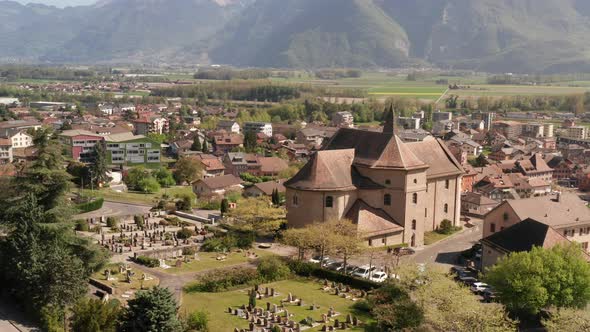 Flying towards beautiful church in Swiss countryside