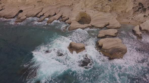 Aerial View of Crashing Waves on Rocks