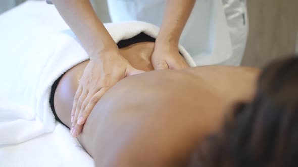 Professional and Qualified Masseuse Making Lower Back Massage