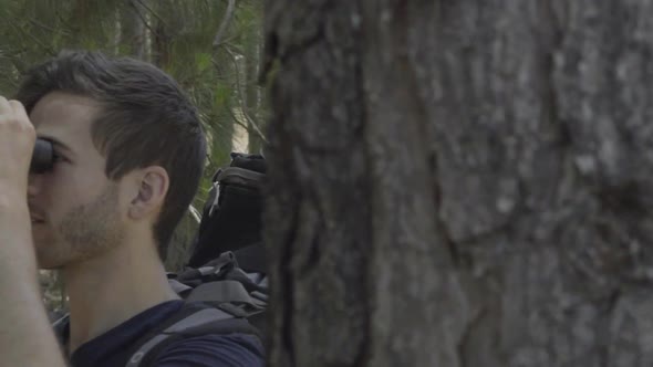 Hiker looking at view through binoculars