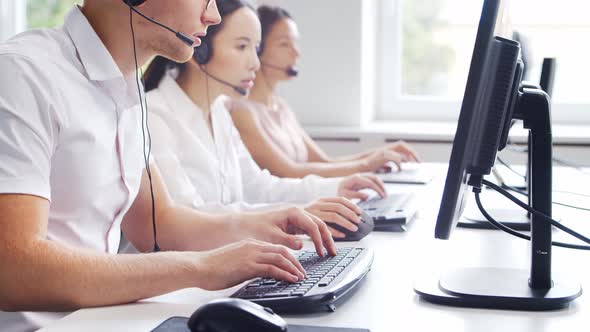 Diverse team of young professionals is working in the phone support office.