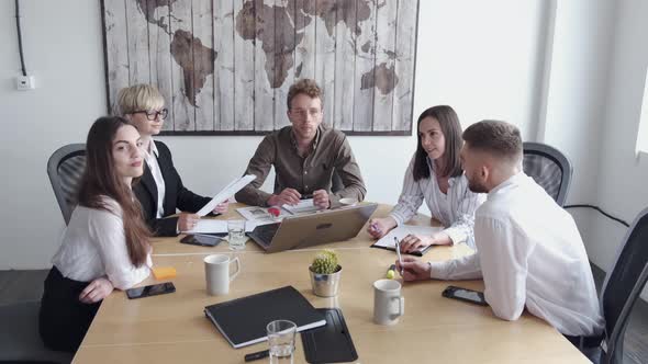 Group of Young People Are Discussing Something in a Modern Office