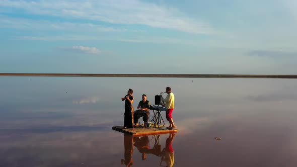 Sunset at the Seaside, Reflections of the Clouds in the Water, Band Is Playing