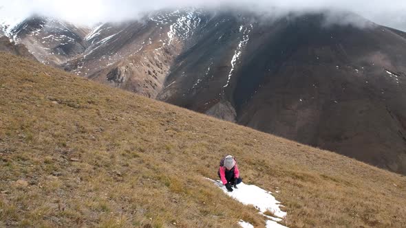 Little Girl Playing Snowballs in Mountains