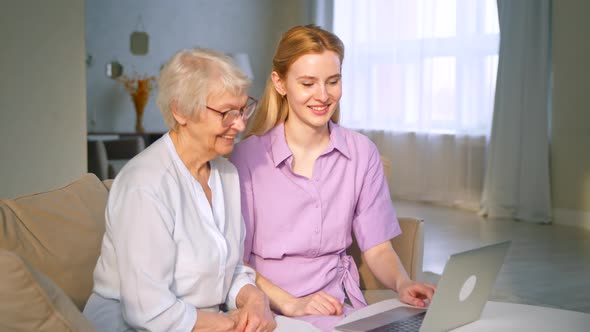 Young daughter and elderly mother talking to family