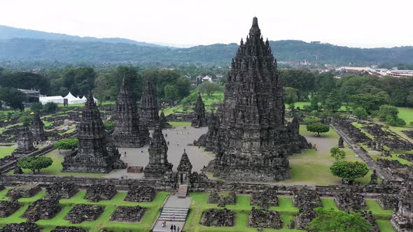 The massive Prambanan Hindu temple in Yogyakarta, Indonesia on overcast day, Aerial pedestal pan rig