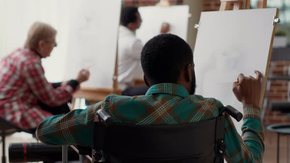 Young Man with Disability Drawing Vase Design at Art Class Lesson