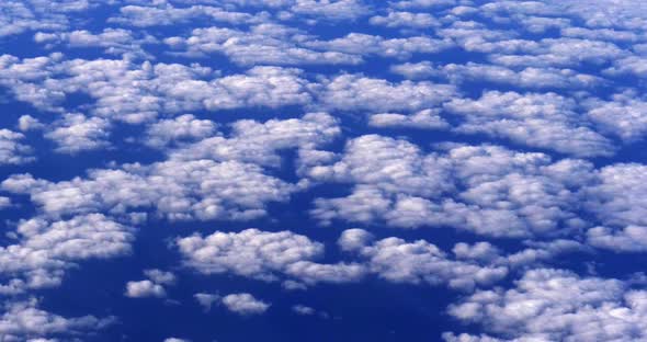 Blue Sky and Clouds from Plane, Flying to Madeira Island in Portugal, slow motion 4K