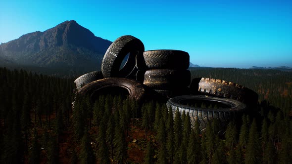 Concept of Environmental Pollution with Big Old Tires in Mountain Forest