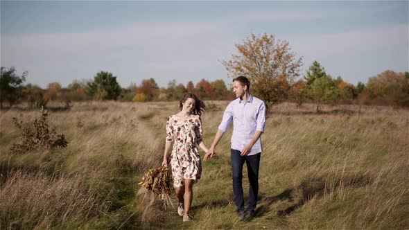 Couple in Love Walking and Holding Hands