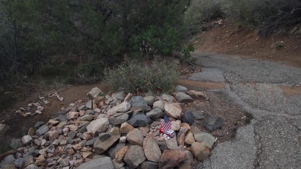 Left pan over a mountain trail memorial for firefighters.