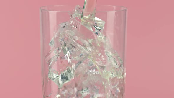 Pouring Drink Into a Glass Full of Ice